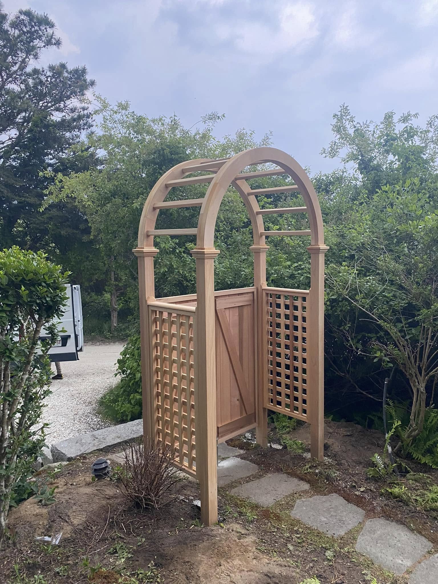 Decorative garden arbor with lattice panels