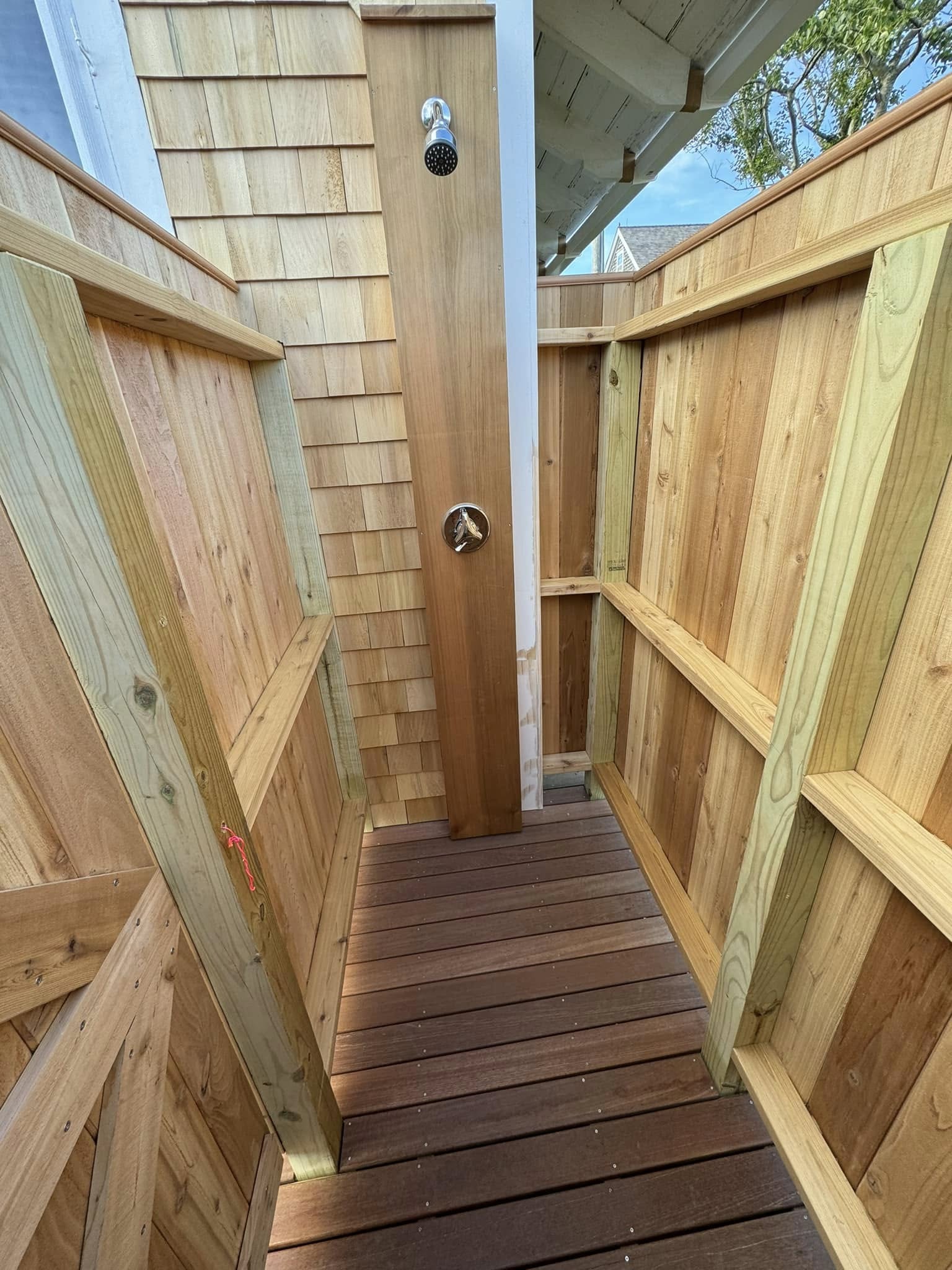 Interior view of cedar outdoor shower with Nantucket shingle siding