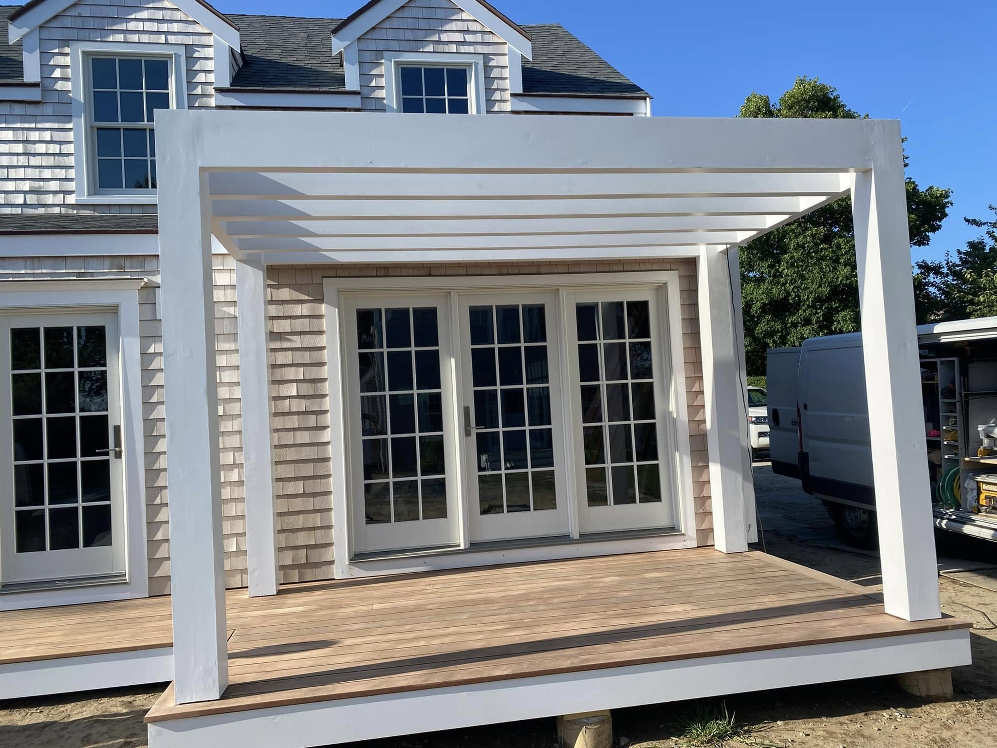 Modern pergola with French doors on Nantucket home